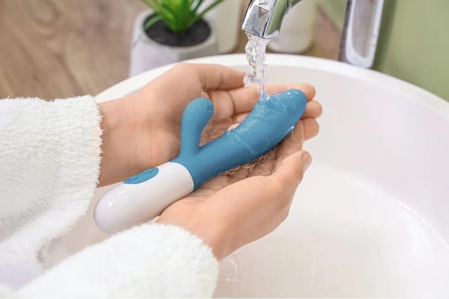 blue-rabbit-vibrator-rinsed-under-water Blue rabbit vibrator being rinsed under running water for easy cleaning