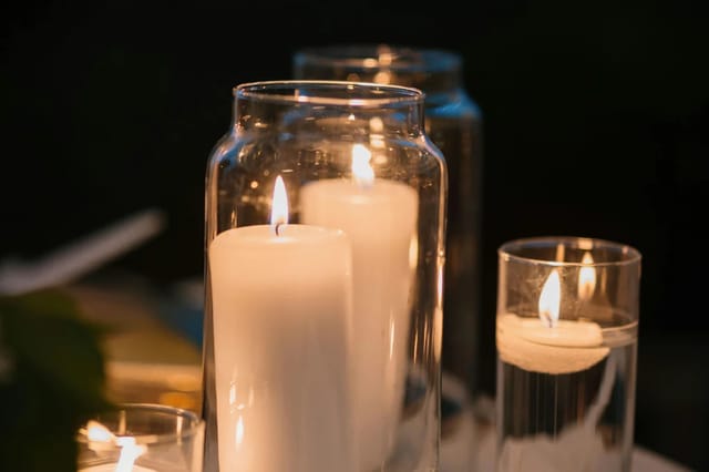 lit-candles-in-glass-holders Lit candles in clear glass holders creating a warm intimate atmosphere.