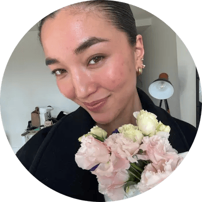 Woman holding soft pink flowers in a natural lifestyle photo