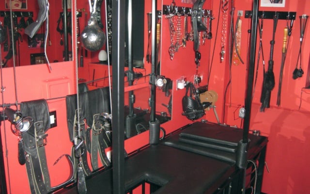 A red sex toy dungeon used for kinky bdsm acts with various sex toys