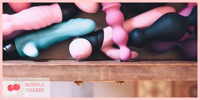 Various sex toys tucked away in a drawer