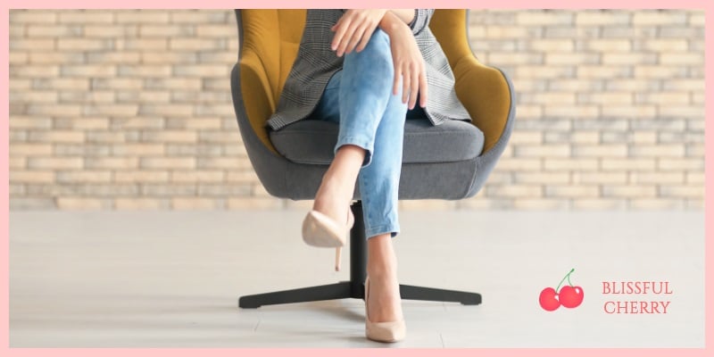 Woman's legs crossed sitting in a chair