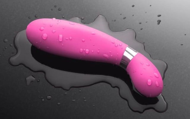Vibrator soaked in water on a black tabletop
